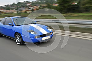 Blue fast sport car on hiway