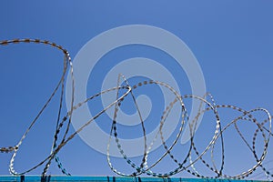 Blue Fence made of wire with spikes on top