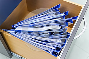 blue file folder documents In a file cabinet retention