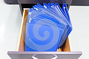 Blue file folder documents In a file cabinet retention of