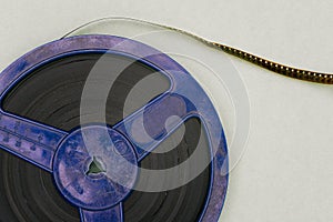 Blue film reel. Recording a film on an old tape. Cinematography and entertainment. Bobbin close-up