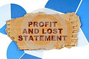 On the blue financial charts is a piece of cardboard that says - Profit and Lost Statement