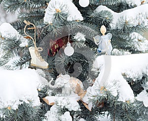 Blue fir-tree is decorated by Christmas toys. Elephants, angel,