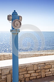 Blue fire hydrant on a sea coast
