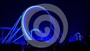 Roller coaster loop lighted at night