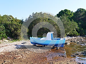 A blue fishing boat in a bay in Croatia