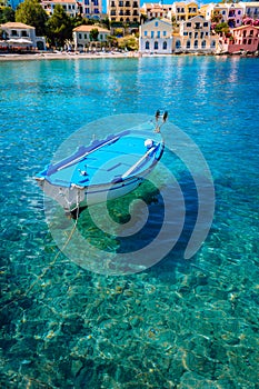 Blue fishing boat in the emerald azure rippled sea water bay in Assos village, Kefalonia island, Greece