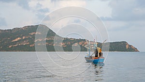 Blue fishing boat floating in the sea