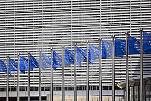 Blue flags of Europe in front of Berlaymont, seat of the European Commission, Brussels, Belgium