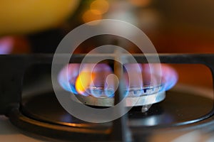 Blue flame of a burning gas stove burner. Close-up, selective soft focus