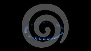 Blue flame of gas stove kitchen burner. The power of the flame changes