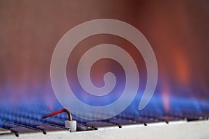 Blue flames of a gas burner inside of a boiler