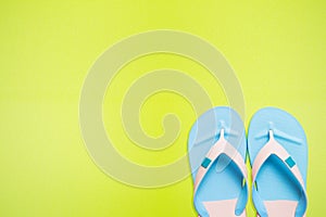 Blue flip flop on green background