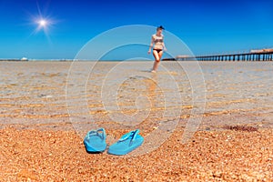 Blue flip flop, sea