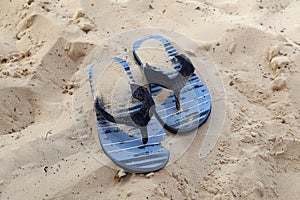 Blue flip-flops on the beach