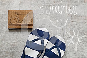 Blue flip flops Text summer on a wooden surface