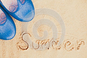 Blue flipflops on sand