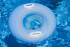 Blue floater with handles in water of pool