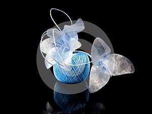 Blue flowers and coil of knits on a black background