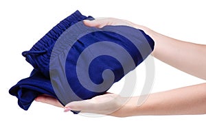 Blue folded sweatpants clothing in hand