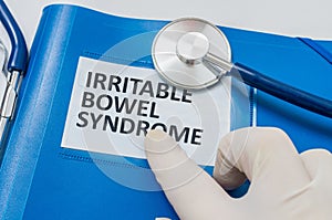 Blue folder with patient files with IBS (Irritable Bowel Syndrome) diagnosis photo