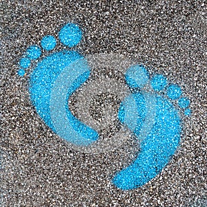 Blue footprint signs on an asphalt