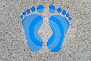 Blue footstep symbols painted on the floor to guide for the position. Decision making, choices concept, where to go