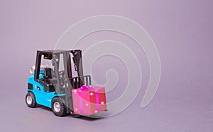 Blue forklift truck carries a pink gift box with a bow. Purchase and delivery of a present. retail, discounts and contests photo
