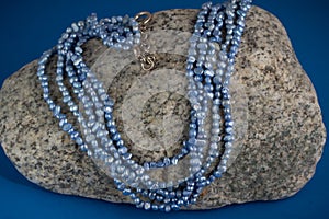 Blue freshwater pearls on granite