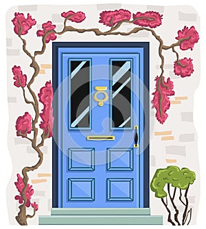 Blue front door with brick wall, steps, climbing pink plants and bush.