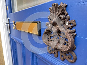Blue front door with door knocker