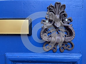 Blue front door with letterbox door knocker