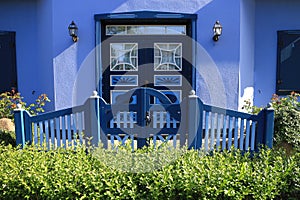 Blue front facade of a modern house with entrance door