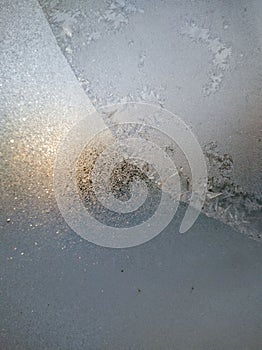 Blue Frost Background, Closeup Frozen Winter Window Pane Coated Shiny Icy Frost Patterns. Natural Ice Pattern on a