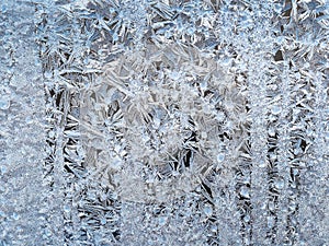 Blue frost pattern on window glass closeup
