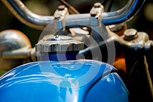 Blue fuel tank and silver cover of vintage Japanese motorcycle