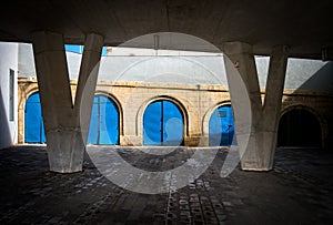Blue garages under the bridge at the port of Malta`s capital. Valleta photo