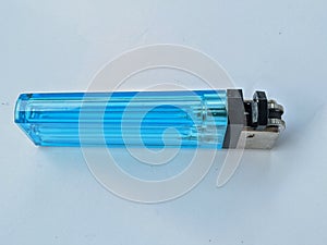 Blue gas lighter on plain white paper