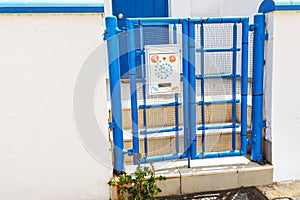 Blue gate with decorated mailbox