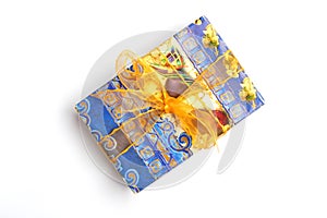 Blue gift box with golden bow on a white background for isolation