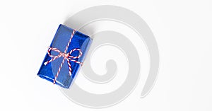 Blue gift box with red ribbons isolated on white background