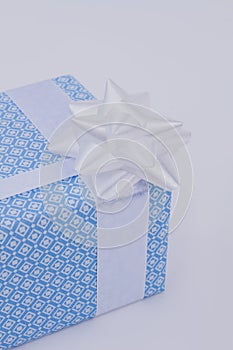 Blue gift box with white bow.