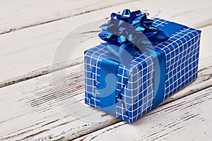 Blue gift box on wood.