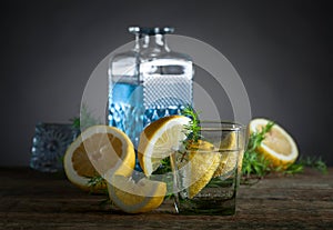 Blue gin , tonic and lemon on a old wooden table.