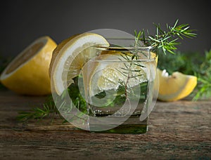 Blue gin , tonic and lemon slices on a old wooden table.