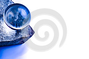 Blue glass ball on a stone