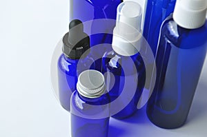 Blue glass bottles for cosmetic lotions, serums, oils