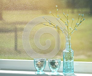 Blue glass bottles sitting on a windowsill