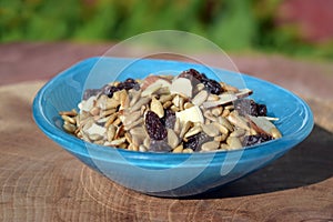 Blue glass bowl filled with nut trail mix