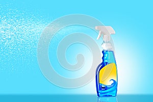 Blue Glass Cleaner Spray Spraying Dispersion Pulverizer with yellow lable on blue background photo